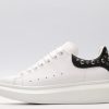 White calf leather lace-up sneaker trimmed with contrasting-color black calf leather heel